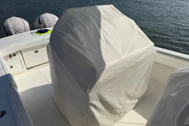 Slide: The Image of 2020 Regulator 31 boat with covered console, docked on calm water. - 45