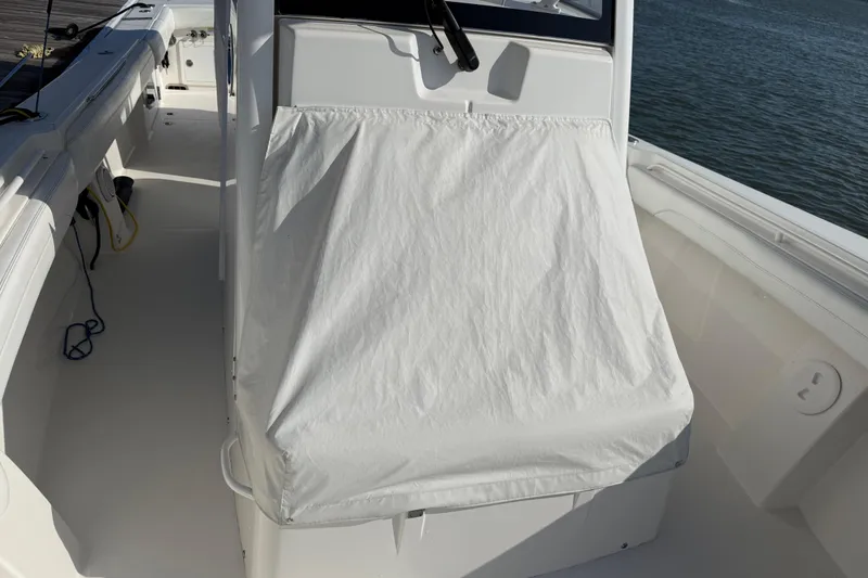Slide: The Image of 2020 Regulator 31 boat console covered, docked by the water. - 46