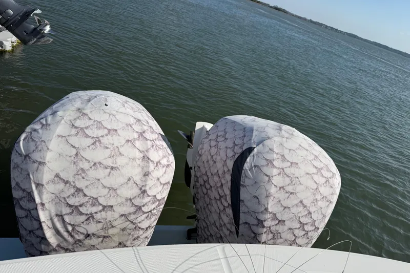 Slide: The Image of 2020 Regulator 31 boat with patterned engine covers on calm water. - 47