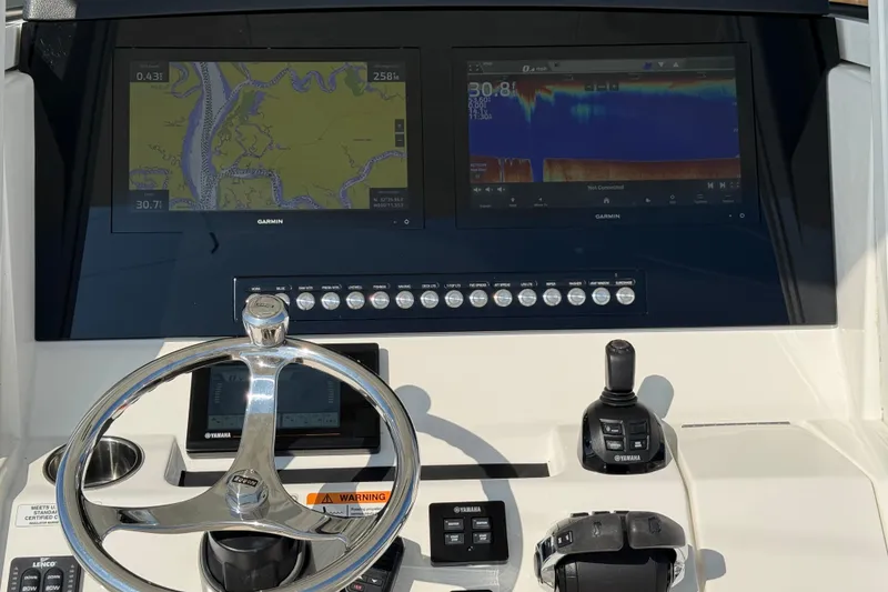 Slide: The Image of Control panel of a 2020 Regulator 31 boat with Garmin navigation displays. - 6
