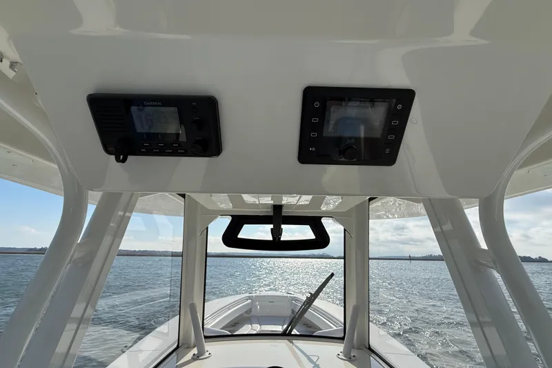 Slide: The Image of 2020 Regulator 31 boat interior with Garmin electronics, overlooking calm waters. - 7