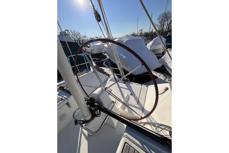 Slide: The Image of 2007 Beneteau First 10R sailboat deck with wheel, winter storage setting. - 20
