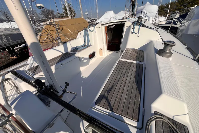Slide: The Image of 2007 Beneteau First 10R sailboat deck with wood accents and open cabin entrance. - 27
