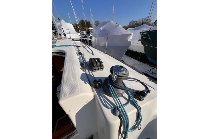 Slide: The Image of 2007 Beneteau First 10R sailboat deck with winch and ropes, docked in marina. - 29