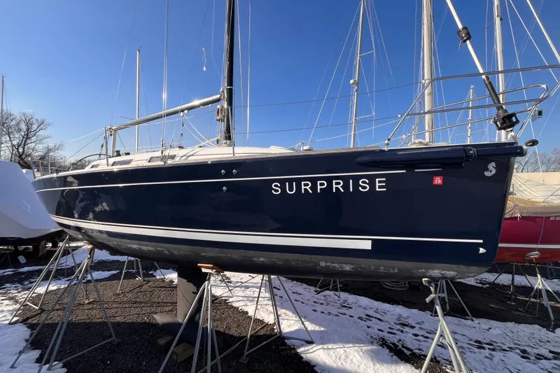 Slide: The Image of 2007 Beneteau First 10R sailboat named "Surprise" on stands in a snowy marina. - 3