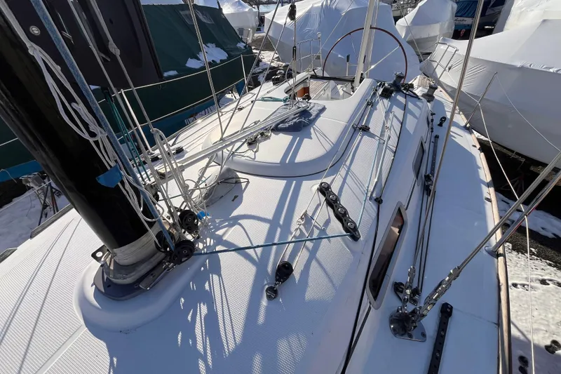 Slide: The Image of 2007 Beneteau First 10R sailboat deck with rigging and snow-covered surroundings. - 34