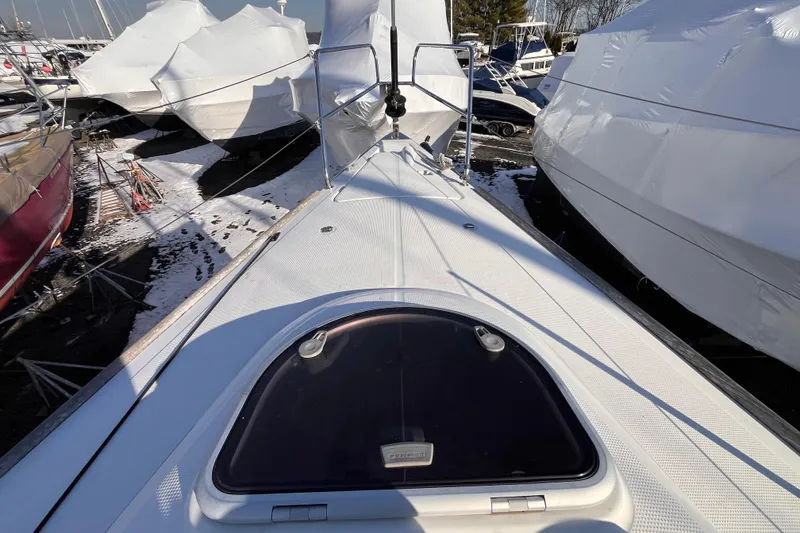 Slide: The Image of 2007 Beneteau First 10R sailboat deck, winter storage, covered boats nearby. - 35