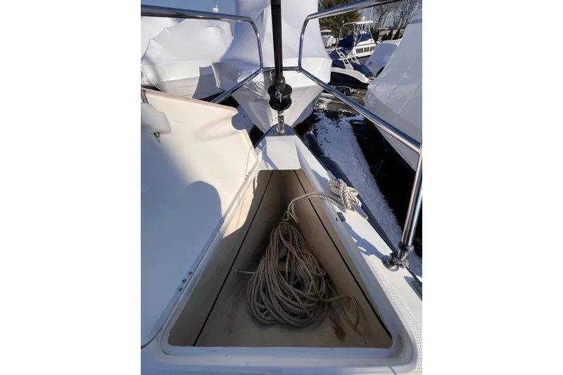 Slide: The Image of 2007 Beneteau First 10R sailboat deck with coiled rope in storage compartment. - 36