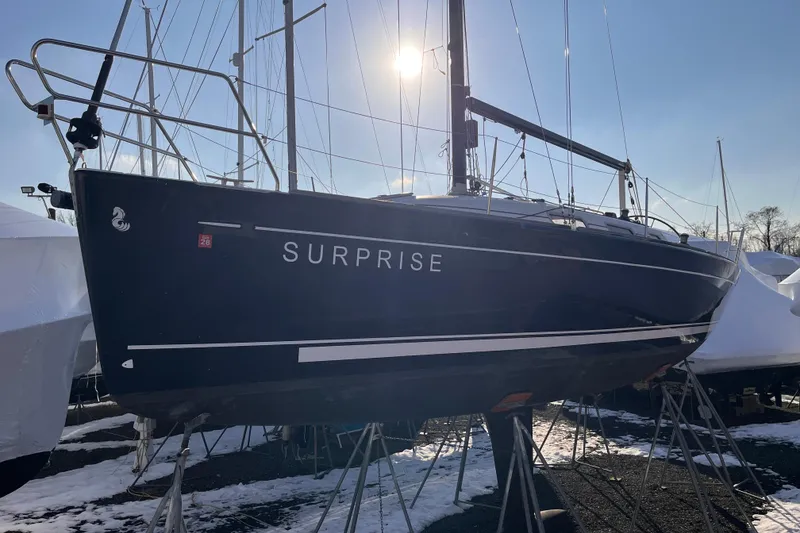 Slide: The Image of 2007 Beneteau First 10R sailboat named "Surprise" on stands, sunlit background. - 4