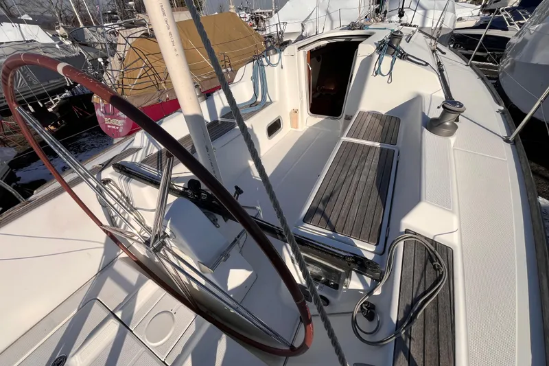 Slide: The Image of 2007 Beneteau First 10R sailboat cockpit with wooden seating and steering wheel. - 44