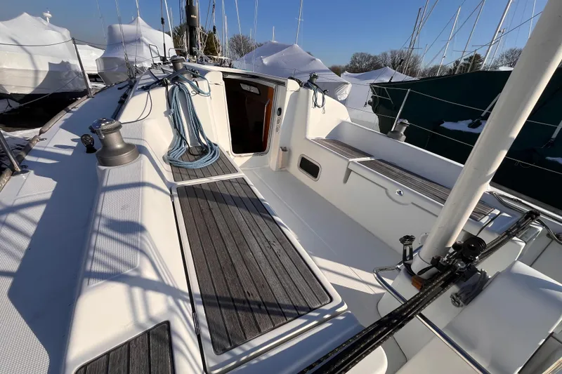 Slide: The Image of 2007 Beneteau First 10R sailboat deck with winch and ropes, docked in marina. - 45