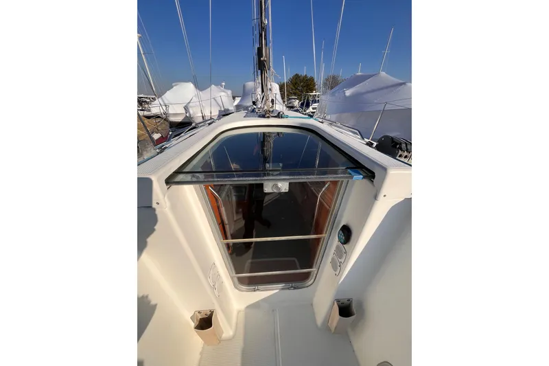 Slide: The Image of 2007 Beneteau First 10R sailboat cockpit with open hatch and clear sky. - 48