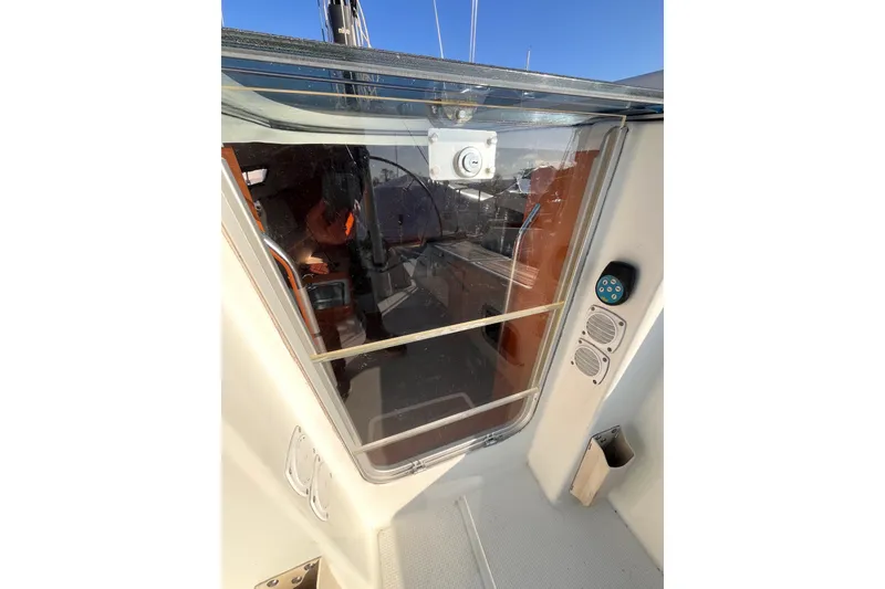Slide: The Image of 2007 Beneteau First 10R yacht cockpit entrance with glass door and control panel. - 50