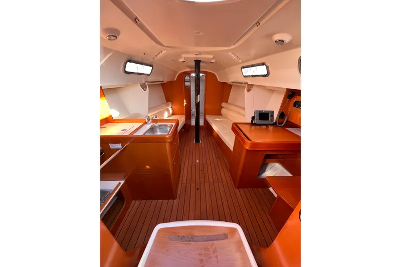 Slide: The Image of Interior of 2007 Beneteau First 10R sailboat with modern wood finish and seating area. - 51
