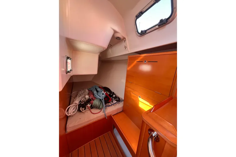 Slide: The Image of 2007 Beneteau First 10R cabin interior with ropes and wooden cabinetry. - 55