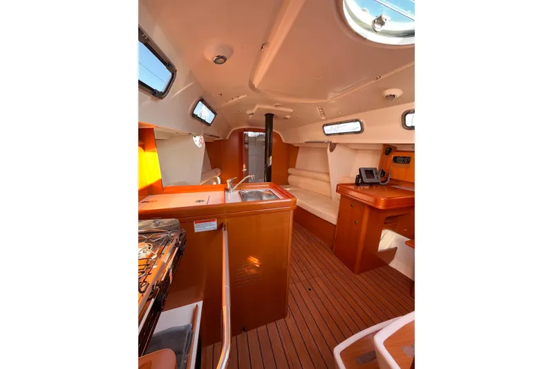 Slide: The Image of Interior of 2007 Beneteau First 10R sailboat with wood finish and modern amenities. - 57