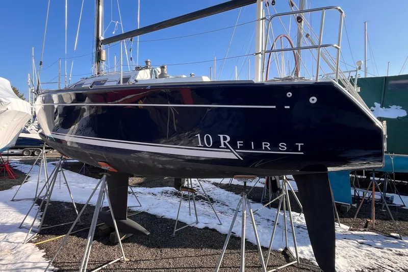 Slide: The Image of 2007 Beneteau First 10R sailboat on stands, winter setting, clear blue sky. - 6