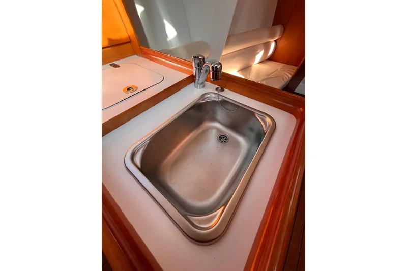 Slide: The Image of 2007 Beneteau First 10R yacht interior with stainless steel sink and wooden countertop. - 61