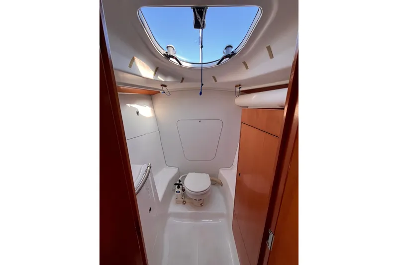 Slide: The Image of 2007 Beneteau First 10R yacht bathroom with skylight and wooden cabinetry. - 69