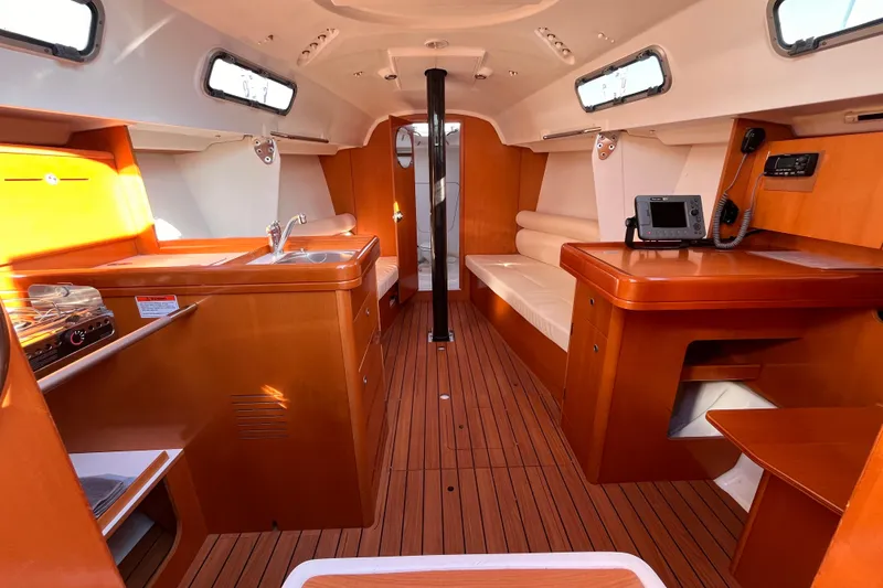 Slide: The Image of Interior of 2007 Beneteau First 10R sailboat with wood finish and modern amenities. - 73