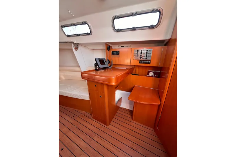 Slide: The Image of 2007 Beneteau First 10R yacht interior with navigation station and wooden flooring. - 74