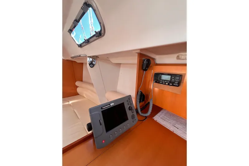 Slide: The Image of 2007 Beneteau First 10R yacht interior with navigation equipment and cozy seating. - 75