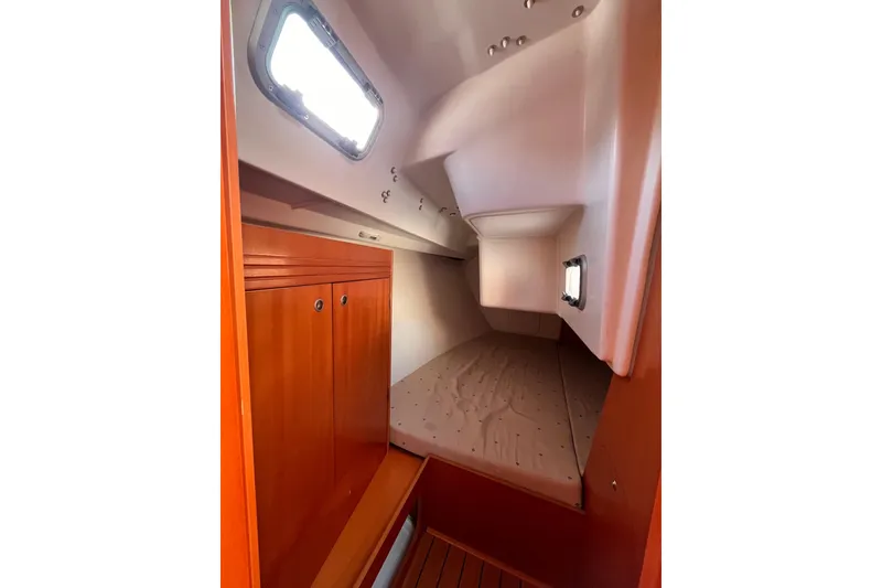 Slide: The Image of Cozy cabin interior of 2007 Beneteau First 10R sailboat with wooden finishes. - 80