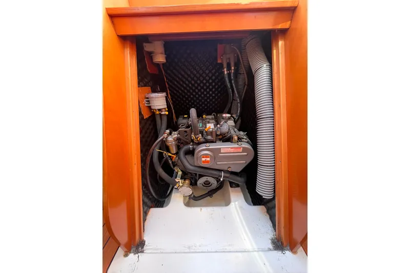Slide: The Image of Engine compartment of 2007 Beneteau First 10R sailboat, showcasing mechanical components. - 82
