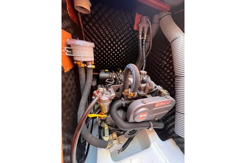 Slide: The Image of Engine compartment of a 2007 Beneteau First 10R sailboat, showcasing detailed components. - 83