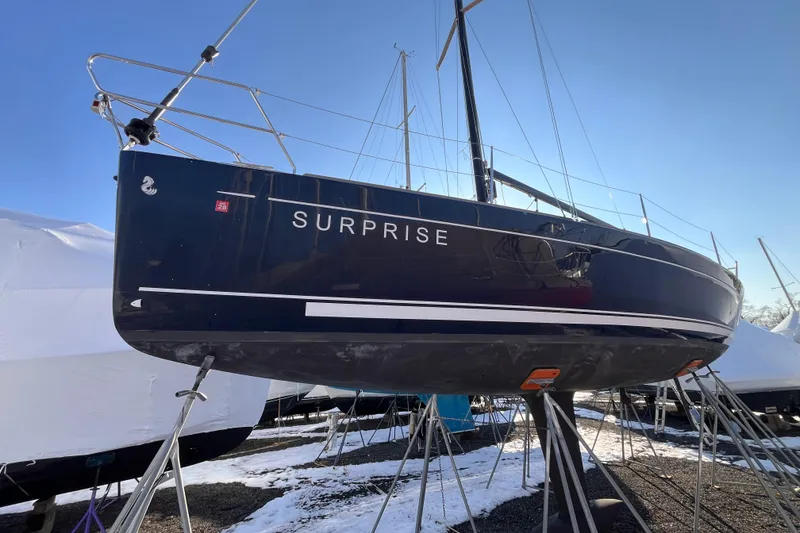 Slide: The Image of 2007 Beneteau First 10R sailboat named "Surprise" on stands in a snowy boatyard. - 9