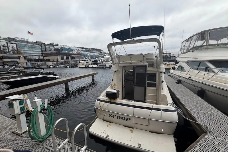 Slide: The Image of 2001 Bayliner 3258 Command Bridge docked at a marina, overcast sky. - 10