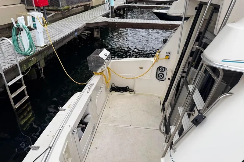 Slide: The Image of 2001 Bayliner 3258 Command Bridge at dock, showing deck and marina setup. - 13