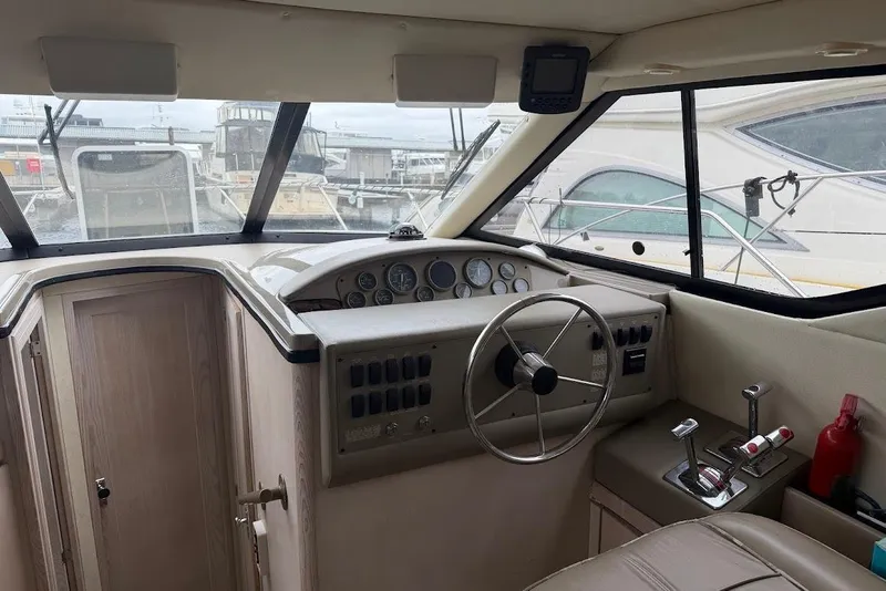 Slide: The Image of 2001 Bayliner 3258 Command Bridge helm with steering wheel and control panel. - 4