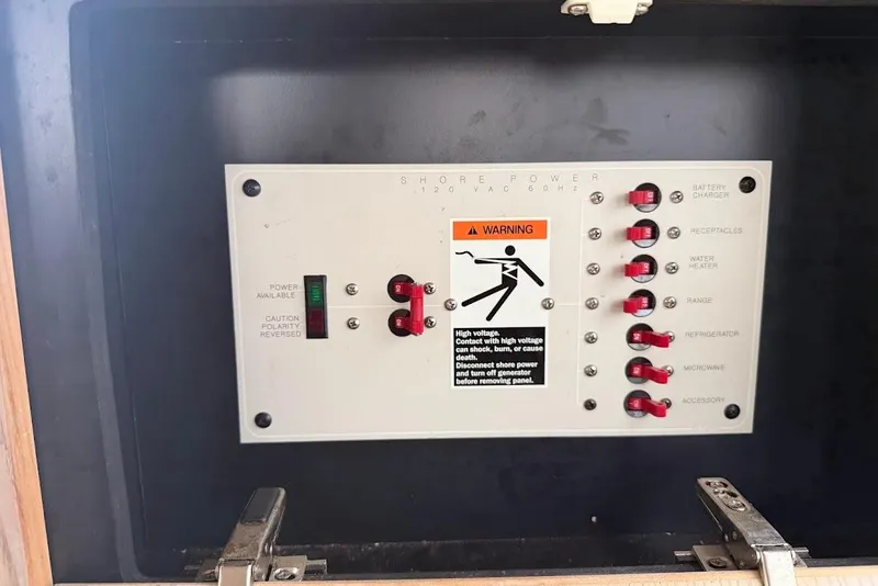 Slide: The Image of Electrical panel on a 2001 Bayliner 3258 Command Bridge boat with warning label. - 6