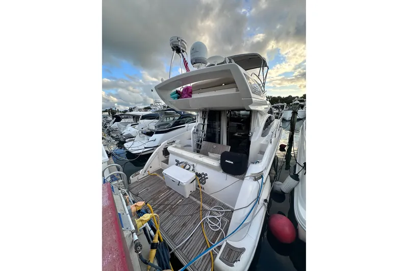 The Image of Luxury Azimut 38 yacht, 2011 model, docked at marina under cloudy sky. - 1