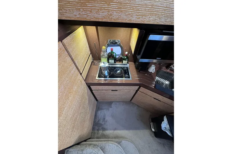 Slide: The Image of Compact kitchen area in a 2011 Azimut 38 yacht with stove and storage. - 12