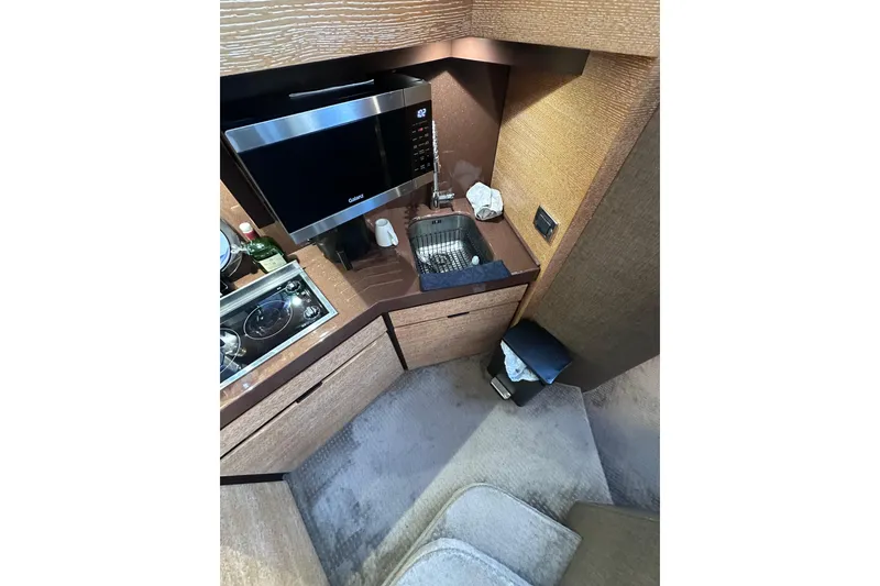 Slide: The Image of Compact kitchen area in a 2011 Azimut 38 yacht with microwave and sink. - 13