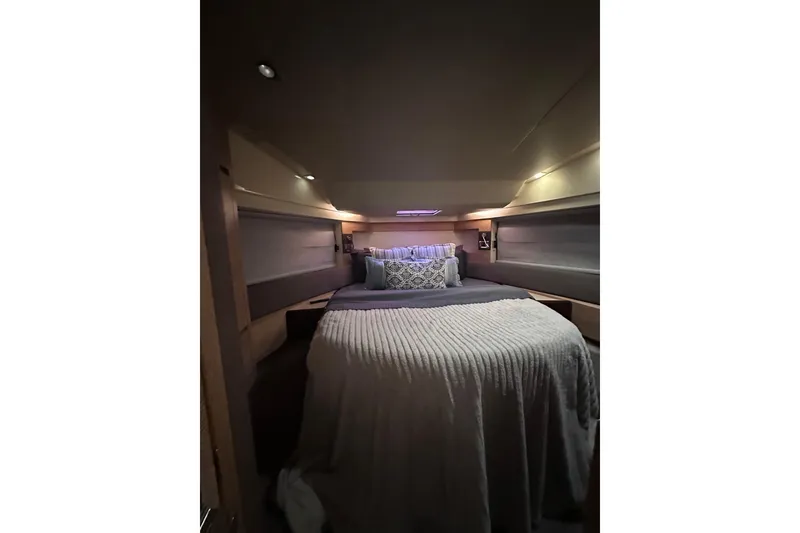 Slide: The Image of Luxurious bedroom interior of 2011 Azimut 38 yacht with cozy bedding and ambient lighting. - 16