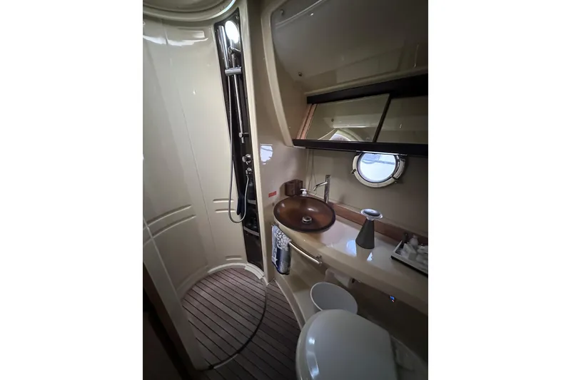 Slide: The Image of Luxurious bathroom in 2011 Azimut 38 yacht with modern fixtures and porthole window. - 17