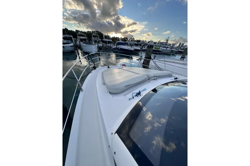 Slide: The Image of 2011 Azimut 38 yacht docked at marina under a cloudy sky. - 24