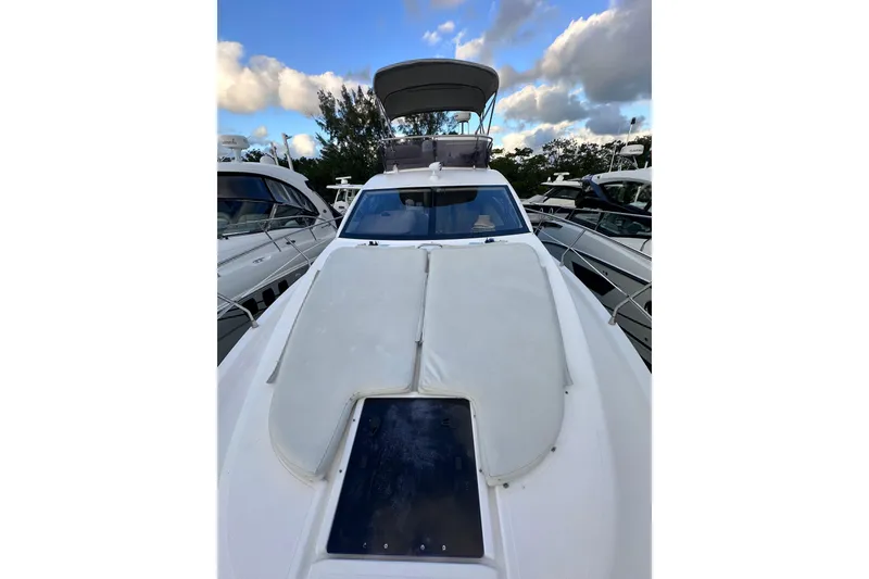 Slide: The Image of 2011 Azimut 38 yacht with sleek design, docked under a partly cloudy sky. - 26