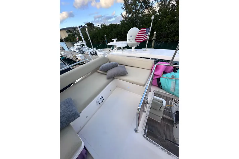 Slide: The Image of 2011 Azimut 38 yacht deck with seating, cushions, and American flag. - 27