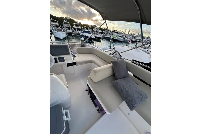 Slide: The Image of Luxurious 2011 Azimut 38 yacht interior with plush seating, docked at a marina during sunset. - 28