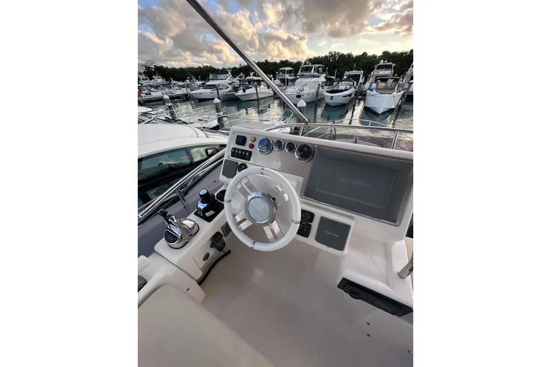 Slide: The Image of Cockpit view of 2011 Azimut 38 yacht with marina backdrop. - 30