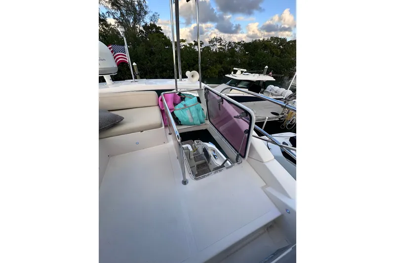 Slide: The Image of 2011 Azimut 38 yacht deck with seating, bags, and American flag in marina setting. - 32