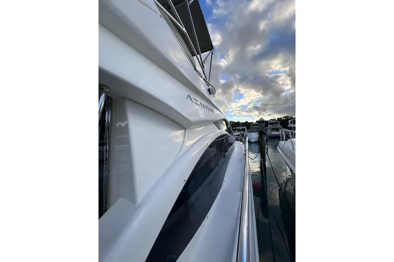 Slide: The Image of 2011 Azimut 38 yacht docked under a cloudy sky. - 7