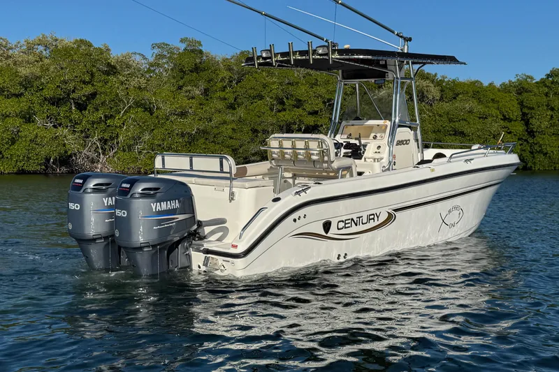 Slide: The Image of 2003 Century 2600 Center Console boat with twin Yamaha engines on water. - 2