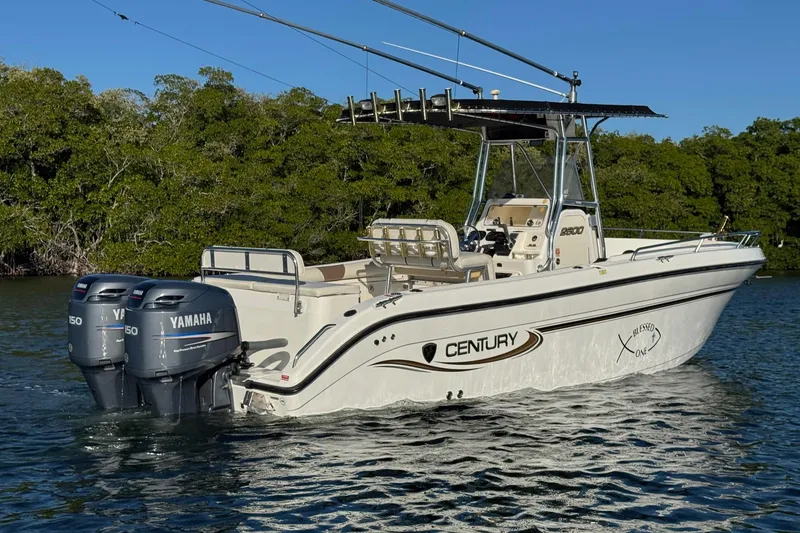Slide: The Image of 2003 Century 2600 Center Console boat with twin Yamaha engines on a calm waterway. - 3
