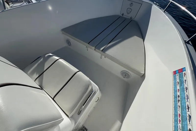Slide: The Image of 2003 Century 2600 Center Console boat interior with cushioned seating and fish measurement guide. - 6