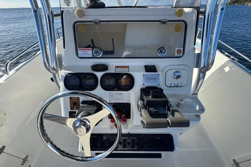 Slide: The Image of 2003 Century 2600 Center Console boat dashboard with steering wheel and controls. - 7